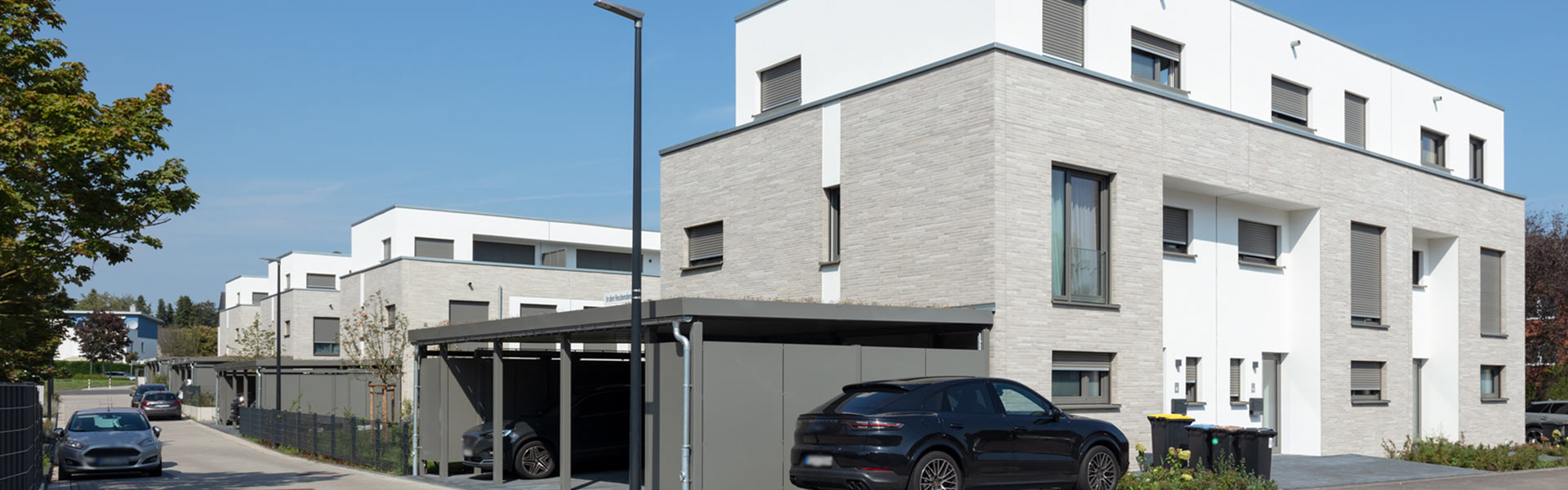 Moderne Reihenhäuser mit Garagen und Autos